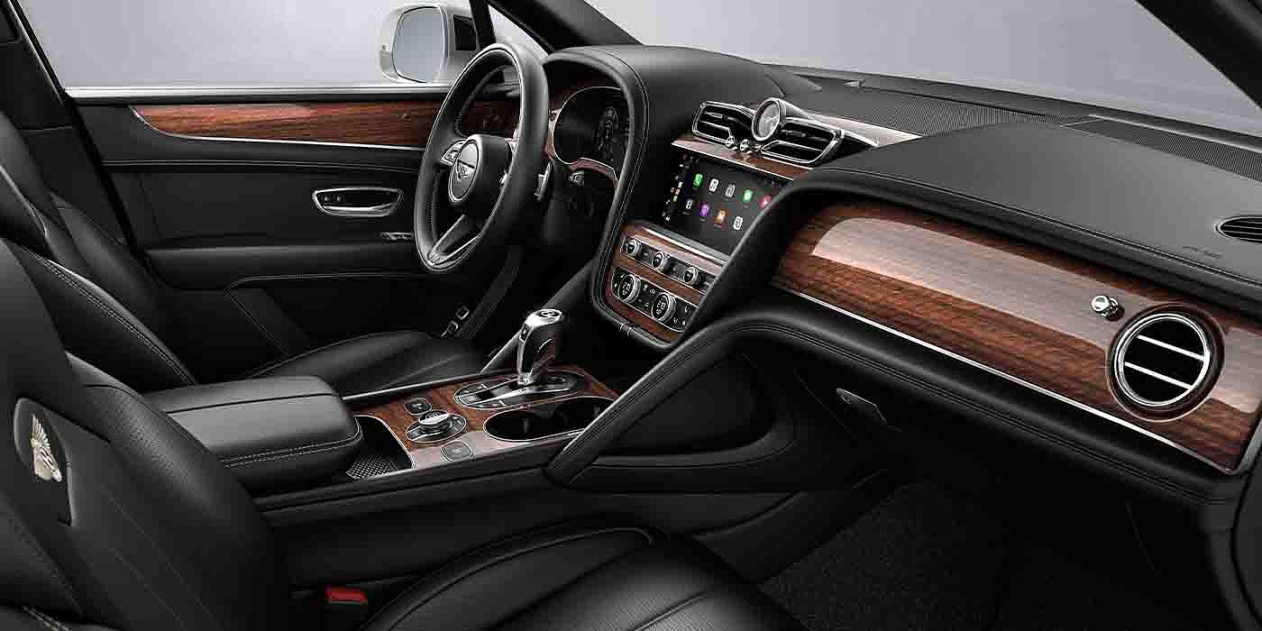 Bentley Jinan Bentley Bentayga EWB interior with a Crown Cut Walnut veneer, view from the passenger seat over looking the driver's seat.